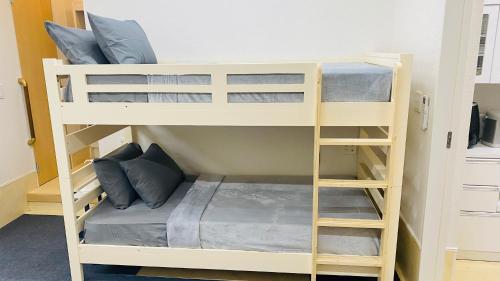 a couple of bunk beds in a room at THE CAMILLE PLACE Tokyo Edogawa has direct access to Akihabara and Shinjuku, with convenient transportation and free WiFi in Tokyo