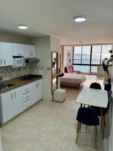 a kitchen and living room with a view of the ocean at leslies apartamentos in Cartagena de Indias