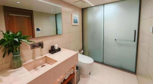 a bathroom with a shower and a sink and a toilet at Huangshan Yupinglou Hotel in Huangshan