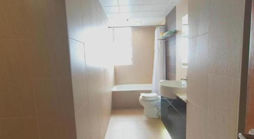 a small bathroom with a toilet and a sink at H1 Hotel in Hong Kong