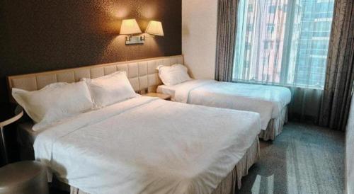 a hotel room with two beds and a window at H1 Hotel in Hong Kong