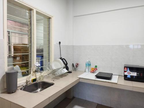 a kitchen with a sink and a window at Event Hubs - Axiata Arena, Stadium Bukit Jalil in Kuala Lumpur