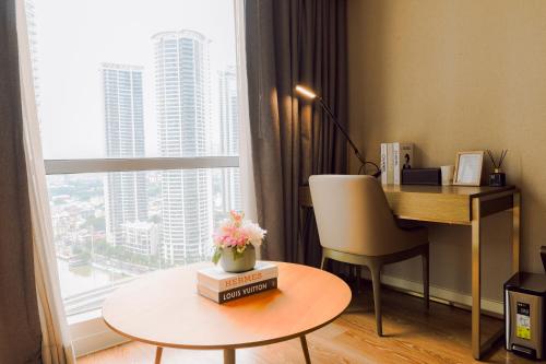 a desk and chair in a room with a large window at The Residences at Novotel Tower in Manila