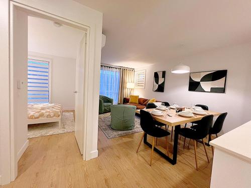 a dining room and living room with a table and chairs at Tiny Penthouse Big Balcony Central & Cozy in Montreal
