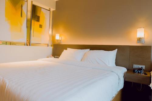 a large white bed in a hotel room at The Residences at Novotel Tower in Manila