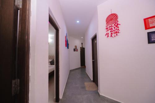 a hallway with a white wall and a hallway with at Hotel Baga inn in Baga