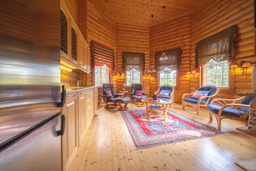 a living room with wooden walls and wooden flooring at Villa River- Luxury Lapland Cabin in Kittilä
