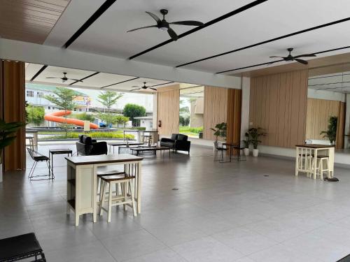 a lobby with tables and chairs in a building at The Pahina Suite in Marilao