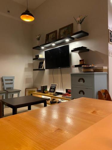 a living room with a table and a flat screen tv at The Pahina Suite in Marilao