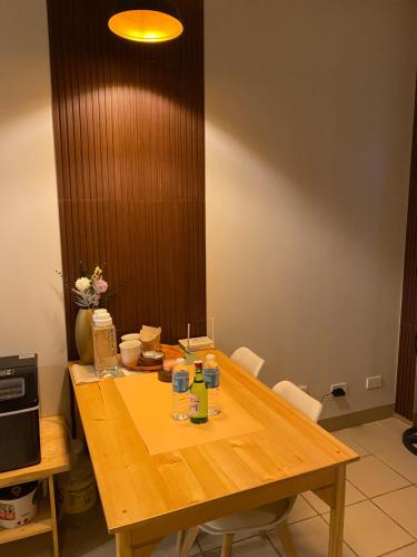 a wooden table with drinks on top of it at The Pahina Suite in Marilao