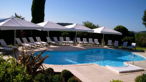 a swimming pool with chairs and umbrellas at Hotel Villa Radin in Vodice