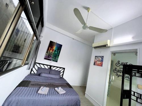 a bedroom with a bed and a ceiling fan at The Eighty8 PP in Phnom Penh