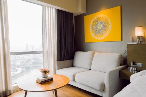 a living room with a couch and a table at The Residences at Novotel Tower in Manila