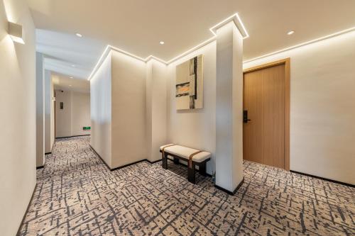 a corridor with a bench in a hallway at Xiaduo B&B in Wangjiazhai