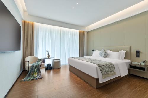 a hotel room with a bed and a television at Xiaduo B&B in Wangjiazhai