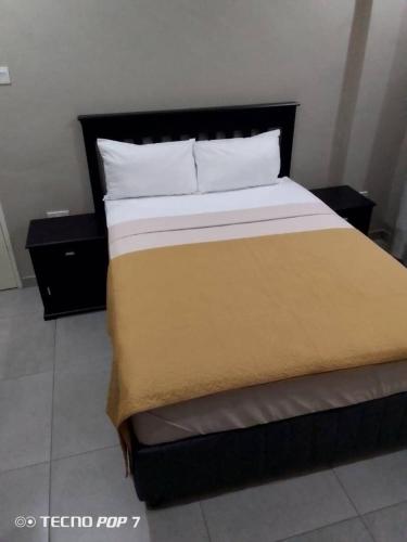 a bedroom with a large bed with two night stands at Kasane Boutique House in Kasane