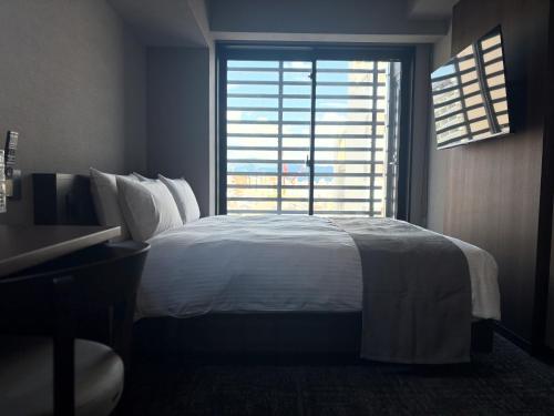 Letto o letti in una camera di hotel bolam kyoto