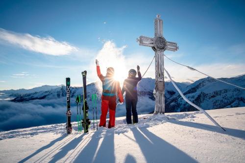 two people standing on top of a snow covered mountain at Apart Garber in Zellbergeben