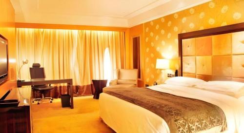 a hotel room with a large bed and a desk at Radegast Hotel CBD in Beijing