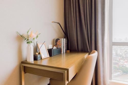 a desk in a room with a window at The Residences at Novotel Tower in Manila