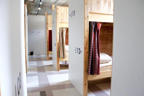 a room with a bunch of bunk beds in it at Hostel TangaTable in Kitakyushu