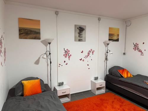a living room with two beds and two lamps at Guest House BiBi in Ilsfeld