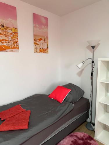 a bedroom with a bed with a red pillow at Guest House BiBi in Ilsfeld