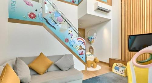 a living room with a couch and a staircase at Huafa Executive Apartment Hotel Zhuhai in Zhuhai