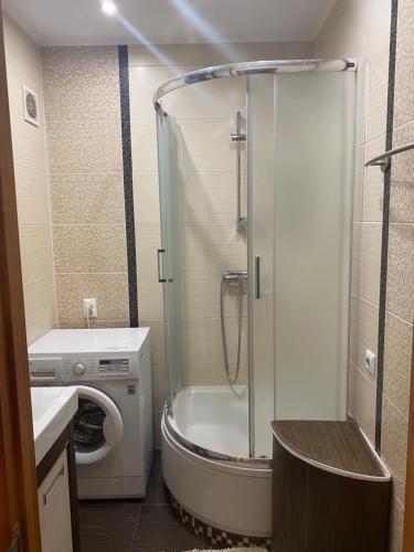une salle de bain avec une douche, des toilettes et un lavabo dans l'établissement Затишна квартира КОМФОРТ, à Oujhorod