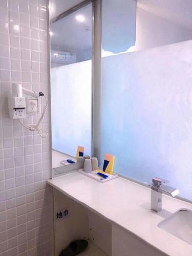 a bathroom with a sink and a mirror at 7 Days Inn·Taixing Wenchang Road in Taixing