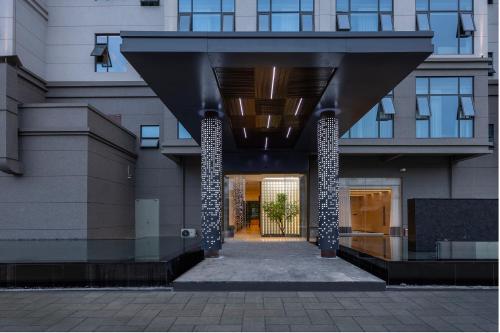 an external view of a building with a hallway at Lan Ou International Hotel in Ruili