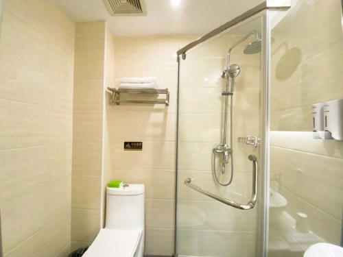 a bathroom with a toilet and a glass shower at 7 Days Premium Hotel Ji'an Taihe Gongnongbing Avenue in Ji'an