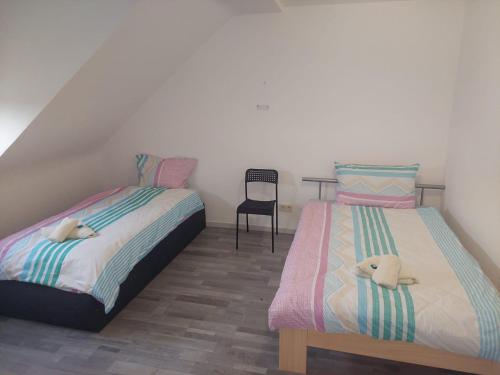 a bedroom with two beds with stuffed animals on them at Appartment Olivia Siegen in Siegen