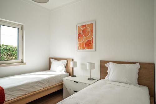 a bedroom with two beds and a window at Bela Vista - Countryside home in Gradil