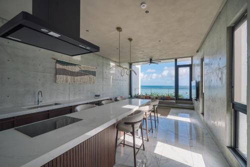 a kitchen with a view of the ocean at CELEVI Yomitan セレビィ 読谷 in Yomitan