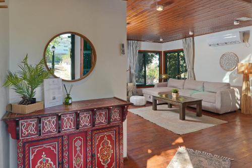 a living room with a couch and a table at THE HOUSE ROSH PINA - 2BRM WITH POOl in Rosh Pinna