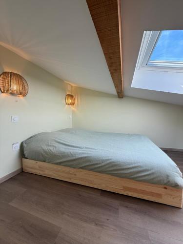 a bed in a room with a window at Duplex appartement en plein centre in Gérardmer