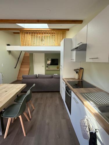 a kitchen and living room with a table and a couch at Duplex appartement en plein centre in Gérardmer