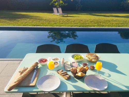 a table with food on it next to a pool at Il Giardino Segreto in Waterloo