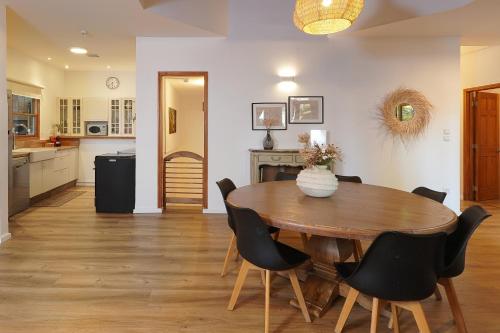 a kitchen and dining room with a wooden table and chairs at הבית בראש פינה - The House in Rosh Pinna