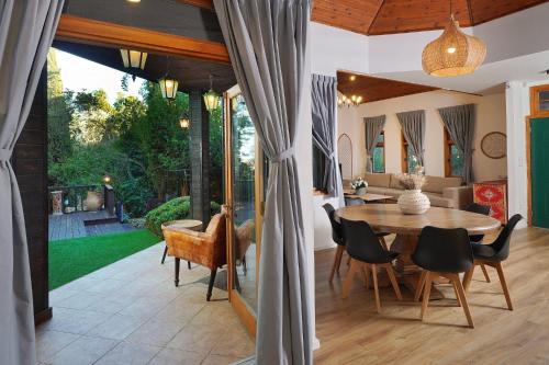 a dining room and living room with a table and chairs at הבית בראש פינה - The House in Rosh Pinna