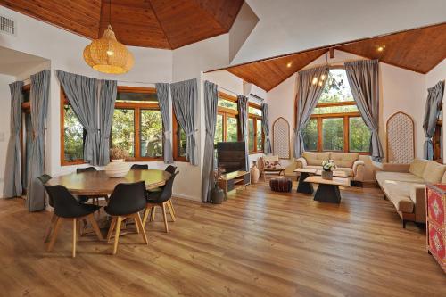 a living room with a table and a couch at הבית בראש פינה - The House in Rosh Pinna