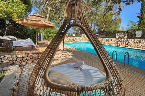 a bed in a hammock next to a pool at הבית בראש פינה - The House in Rosh Pinna
