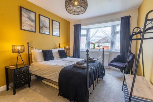 a bedroom with a bed and a chair and a window at HIGHBANK HOUSE - Three Bed Stylish House in North Yorkshire in Harrogate