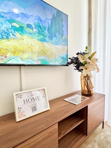 a living room with a tv and a wooden table at Old Porto - Tiny House & Apartment Luxury Garden by MyMoradia in Porto