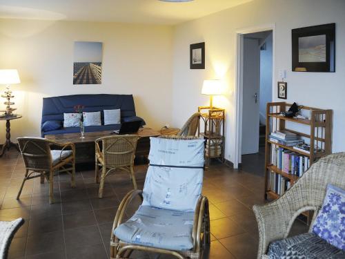 a living room with a couch and a table and chairs at Seaside Comfort in Erquy in Erquy