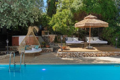 a swimming pool with a hammock and an umbrella at THE HOUSE ROSH PINA - 3BRM WITH POOl in Rosh Pinna