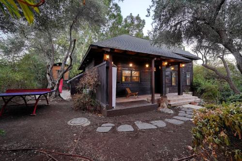 a small cabin with a picnic table in front of it at THE HOUSE ROSH PINA - 3BRM WITH POOl in Rosh Pinna