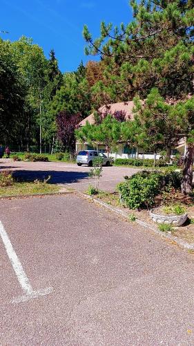an empty parking lot with a car parked in a driveway at Kyriad Direct Metz Nord – Woippy in Woippy