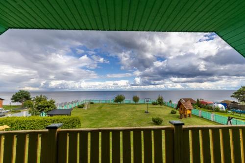 a view from the balcony of a house with a yard at Raja Lake House in Raja